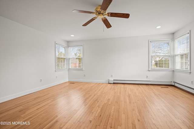 empty room featuring recessed lighting, baseboards, and light wood finished floors