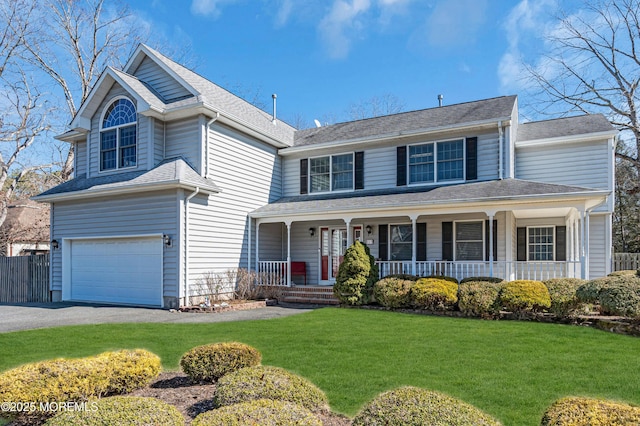 view of front facade with aphalt driveway, covered porch, fence, a garage, and a front lawn