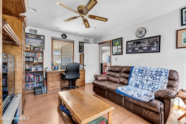 home office with ceiling fan, visible vents, and light wood-style floors