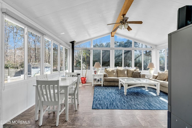 sunroom / solarium featuring lofted ceiling with beams, ceiling fan, and a wealth of natural light