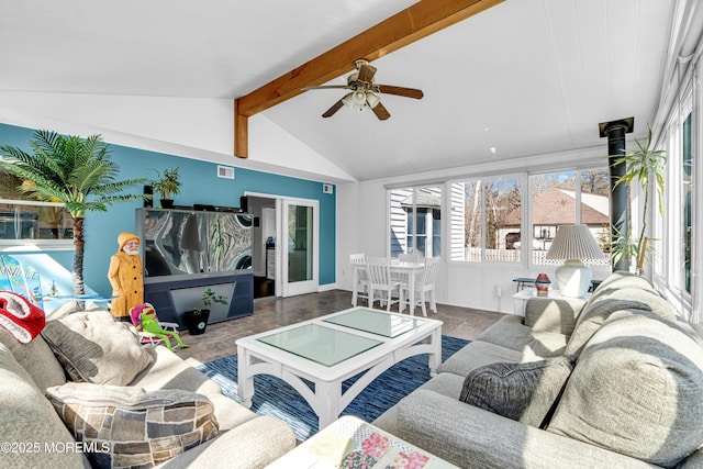 living area with vaulted ceiling with beams, wood finished floors, visible vents, a ceiling fan, and a wood stove