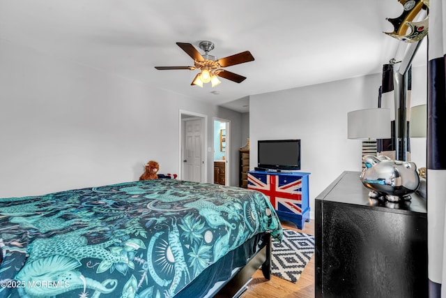 bedroom with a ceiling fan and light wood-type flooring