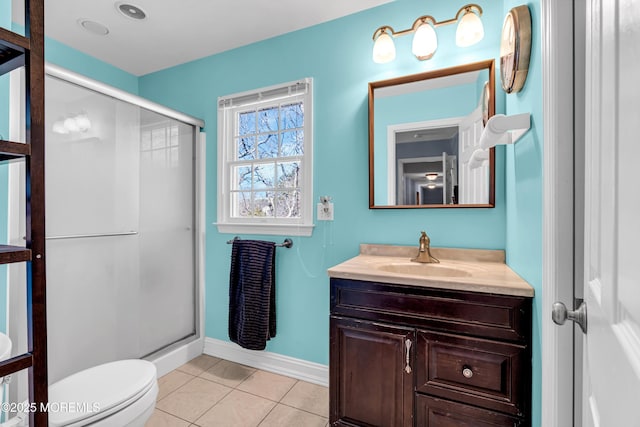 bathroom featuring baseboards, toilet, tile patterned floors, vanity, and a shower stall