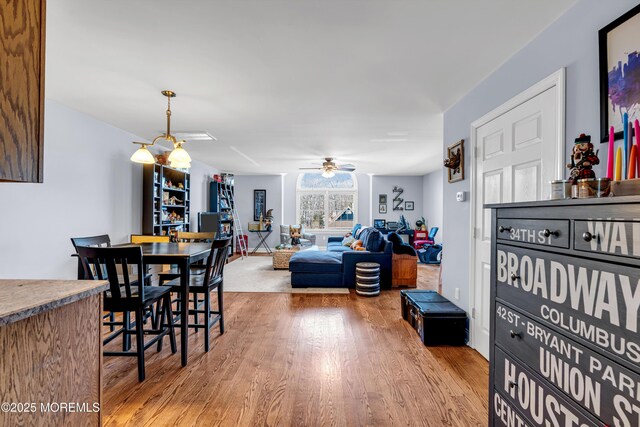 dining area featuring wood finished floors and a ceiling fan