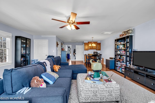 living room featuring a ceiling fan and wood finished floors