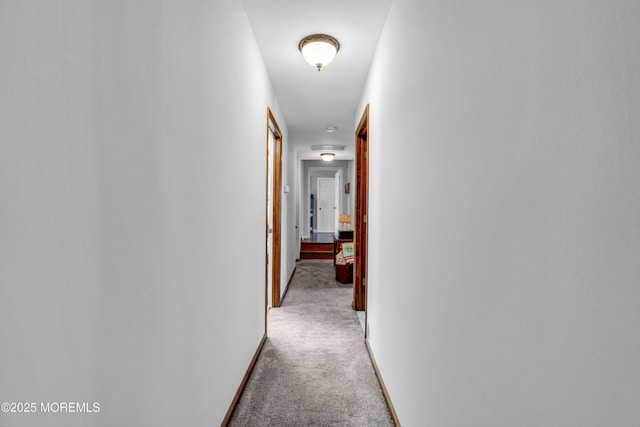 hallway with light carpet and baseboards