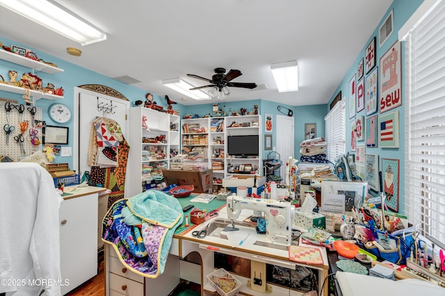 interior space with ceiling fan and visible vents