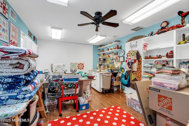 interior space with ceiling fan and visible vents