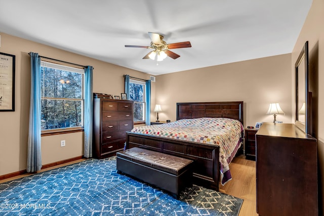 bedroom with dark wood finished floors, baseboards, and ceiling fan