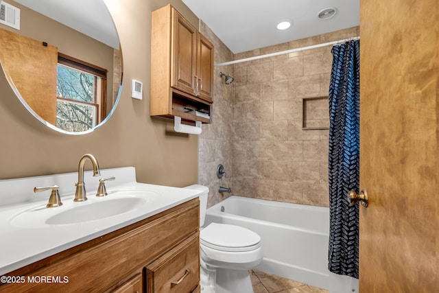 bathroom featuring visible vents, toilet, shower / tub combo, vanity, and tile patterned flooring