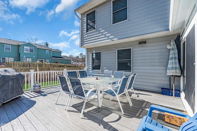 deck featuring fence, outdoor dining area, and area for grilling