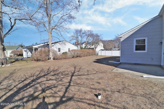 view of yard featuring fence and a patio