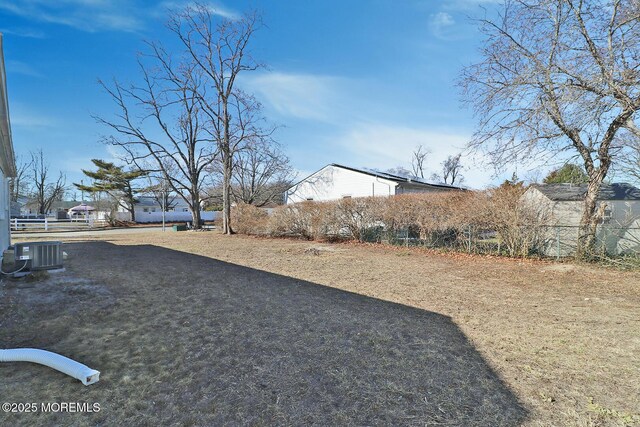 view of side of home featuring fence and cooling unit