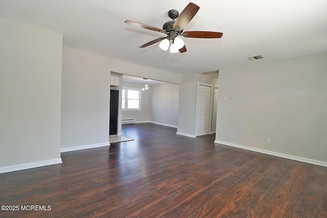 unfurnished room with dark wood-type flooring, a ceiling fan, visible vents, baseboards, and baseboard heating