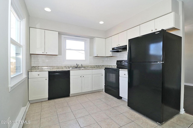 kitchen with black appliances, under cabinet range hood, white cabinets, and a sink