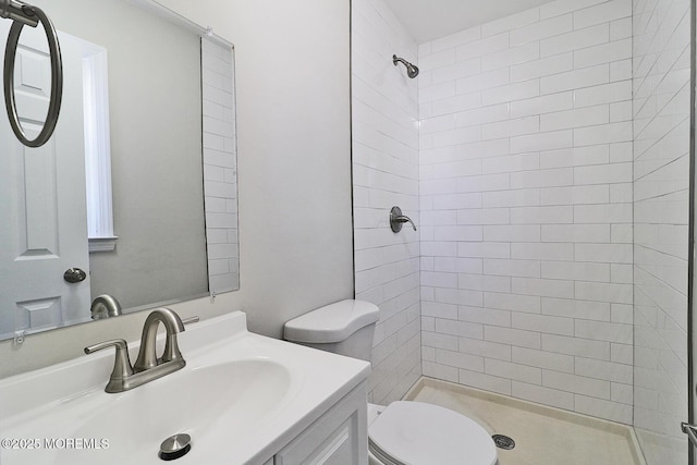 full bathroom with a shower stall, toilet, and vanity