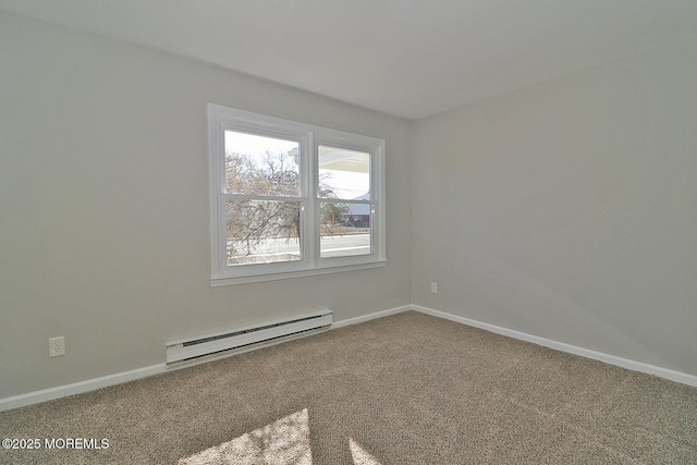 carpeted spare room featuring a baseboard radiator and baseboards