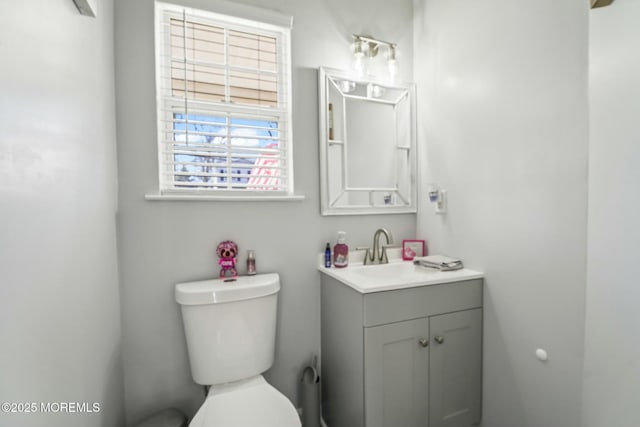 half bath featuring toilet and vanity