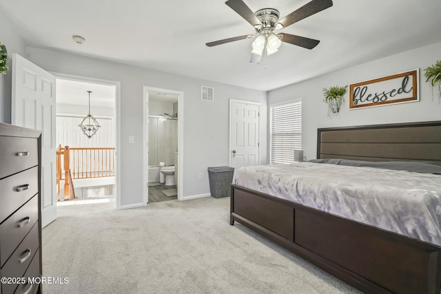 bedroom featuring baseboards, visible vents, ensuite bathroom, carpet floors, and ceiling fan with notable chandelier