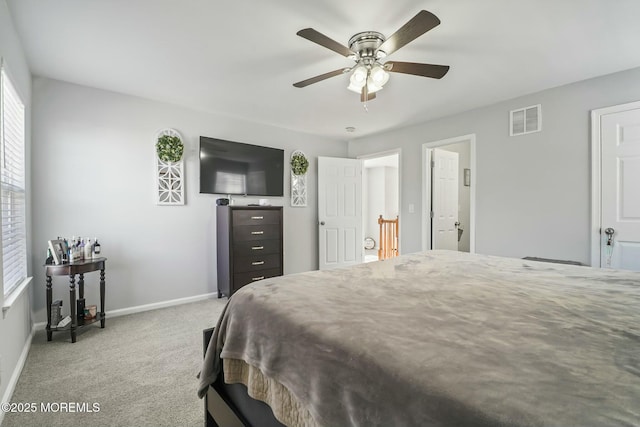 bedroom featuring ceiling fan, carpet flooring, visible vents, and baseboards