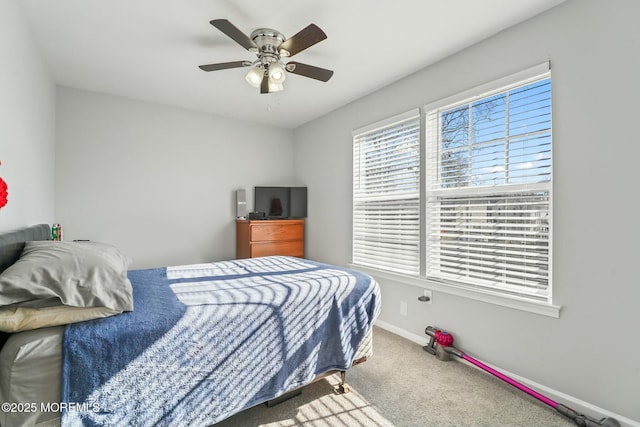 bedroom with a ceiling fan, baseboards, and carpet flooring