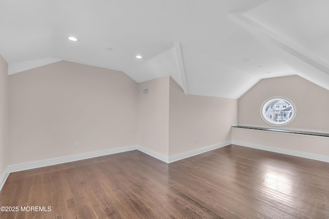 bonus room with vaulted ceiling, wood finished floors, baseboards, and visible vents