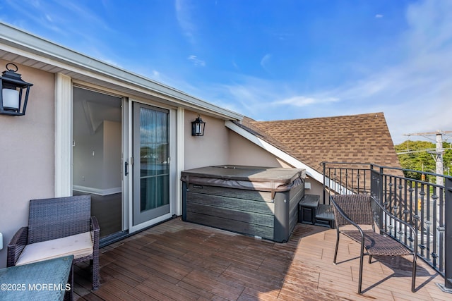 wooden deck featuring a hot tub