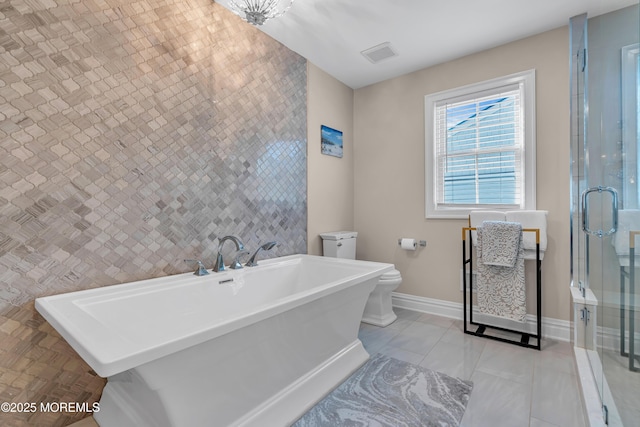 bathroom with baseboards, visible vents, a stall shower, tile patterned floors, and toilet