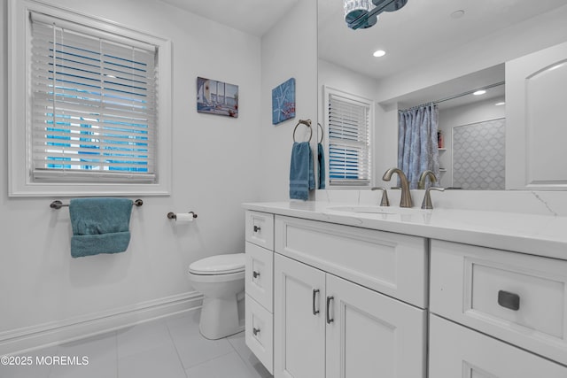 bathroom featuring vanity, a shower with shower curtain, baseboards, tile patterned floors, and toilet