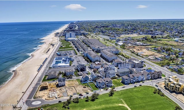 bird's eye view featuring a view of the beach and a water view