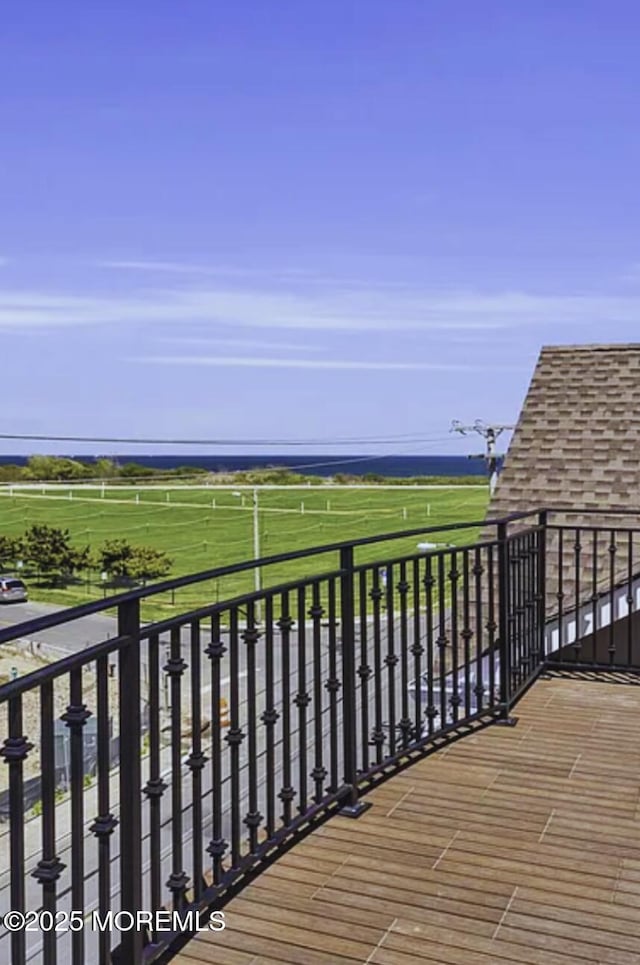 wooden deck with a rural view