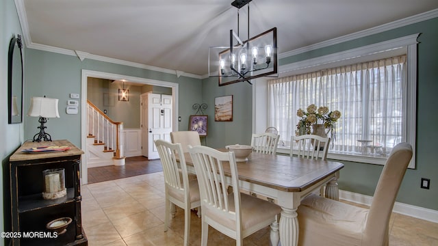 dining room featuring light tile patterned floors, crown molding, baseboards, stairway, and an inviting chandelier