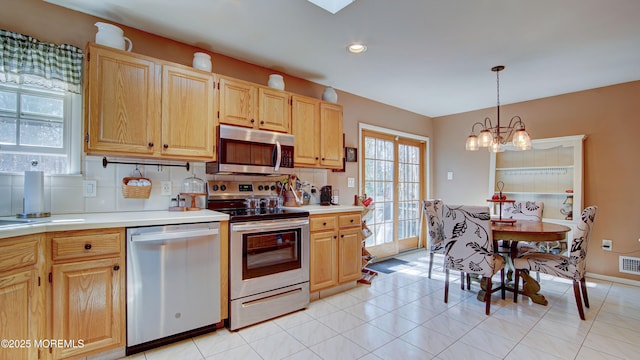 kitchen featuring backsplash, stainless steel appliances, and light countertops