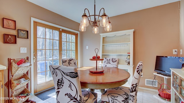 dining room with visible vents, a notable chandelier, and light tile patterned floors