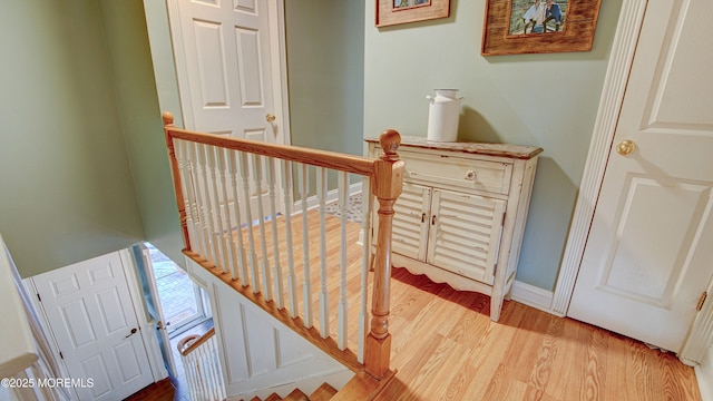 stairway with baseboards and wood finished floors