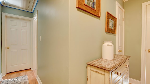 corridor featuring baseboards and light wood-style floors