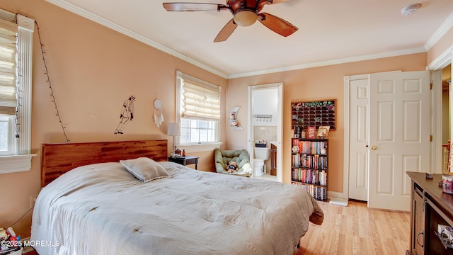 bedroom with ornamental molding, a ceiling fan, and light wood-style floors