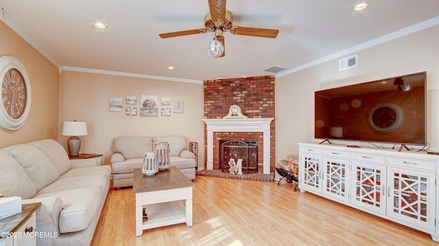 living area featuring ornamental molding, visible vents, and wood finished floors