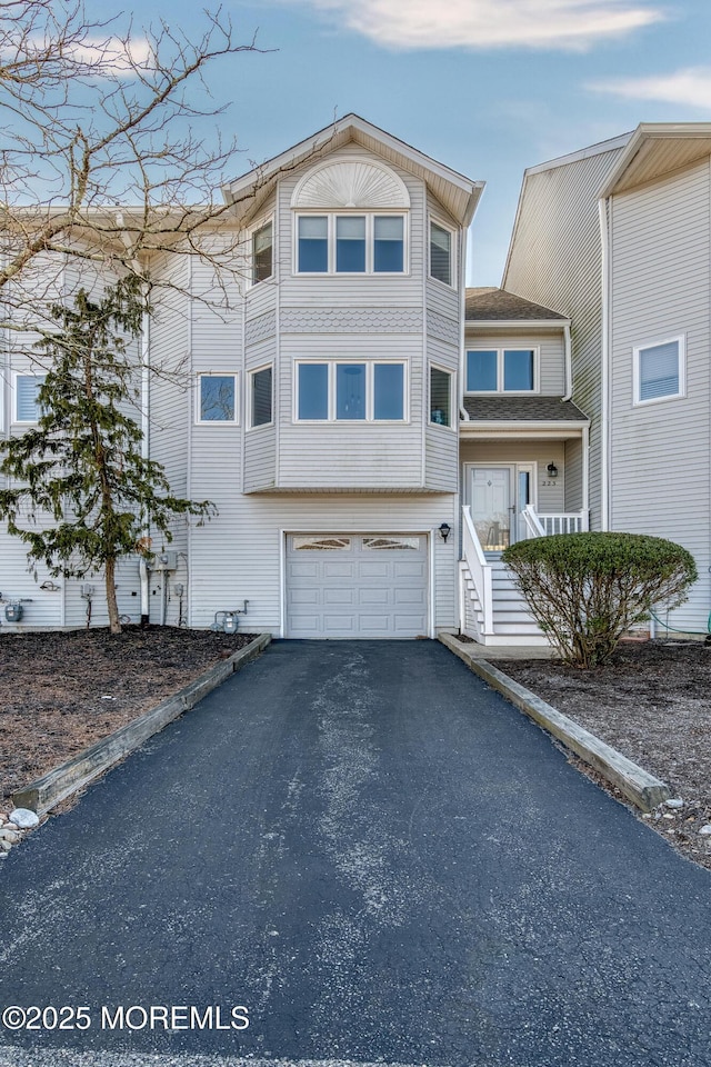 view of front facade featuring aphalt driveway and an attached garage