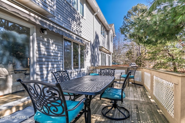 deck with outdoor dining area