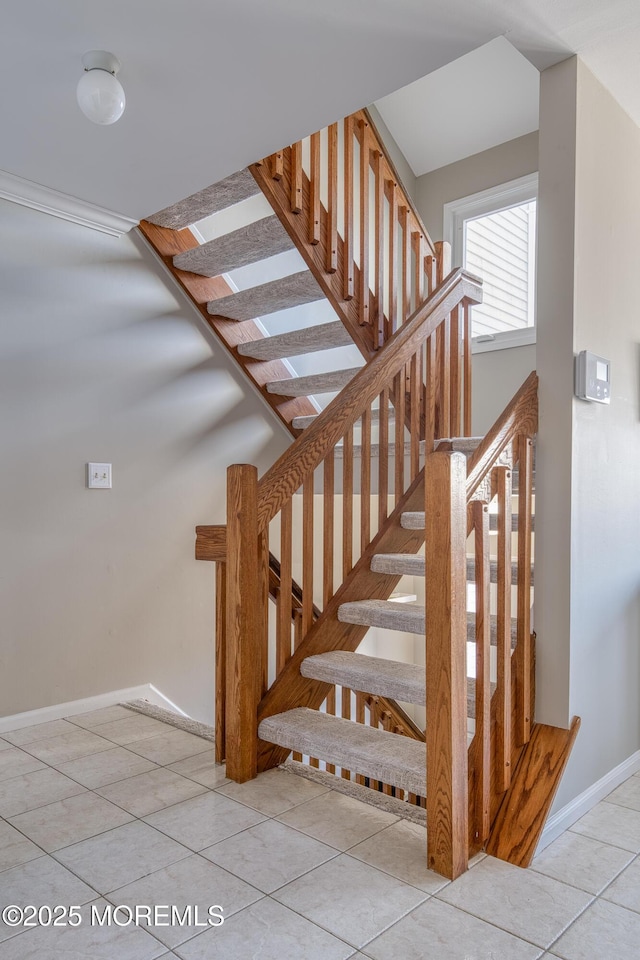 stairway with tile patterned flooring and baseboards