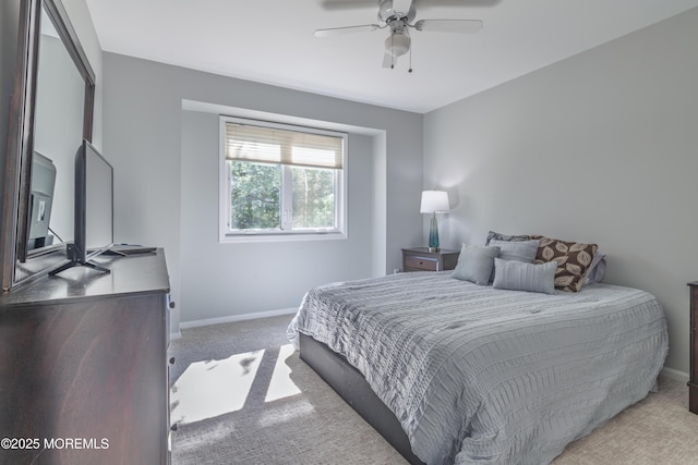 carpeted bedroom featuring baseboards and ceiling fan