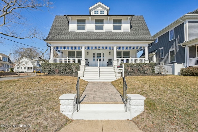 view of front of home with a porch, a shingled roof, and a front lawn