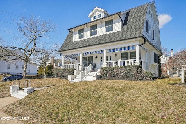 view of front of house featuring a porch, a gambrel roof, roof with shingles, and a front lawn