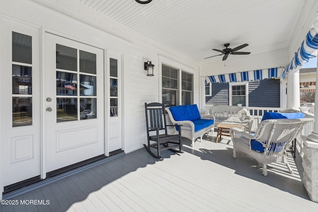 deck with covered porch, a ceiling fan, and french doors