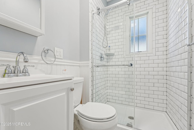 full bath with a shower stall, toilet, and vanity