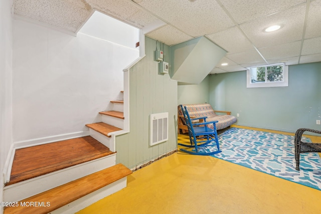 living area with a paneled ceiling, recessed lighting, visible vents, baseboards, and stairway