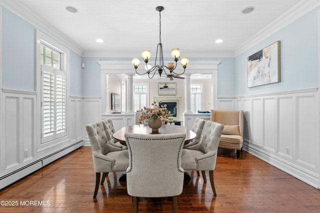 18 Riverdale Ave, Monmouth Beach, NJ 07750 - dining area with baseboard heating, a decorative wall, a chandelier, wainscoting, and dark wood-style floors