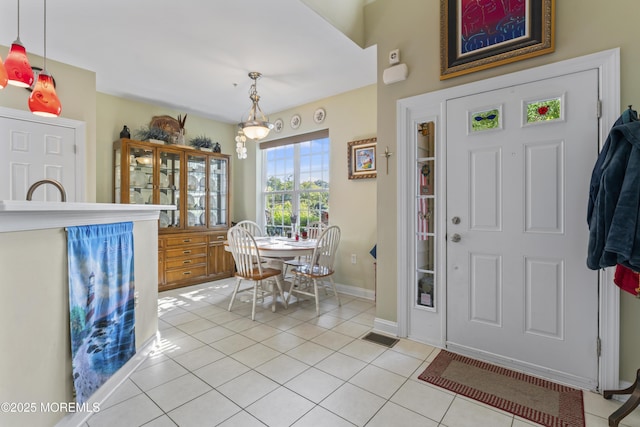 entryway with light tile patterned floors, visible vents, and baseboards