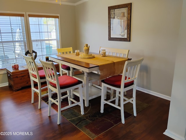 dining room with baseboards, dark wood-type flooring, and ornamental molding